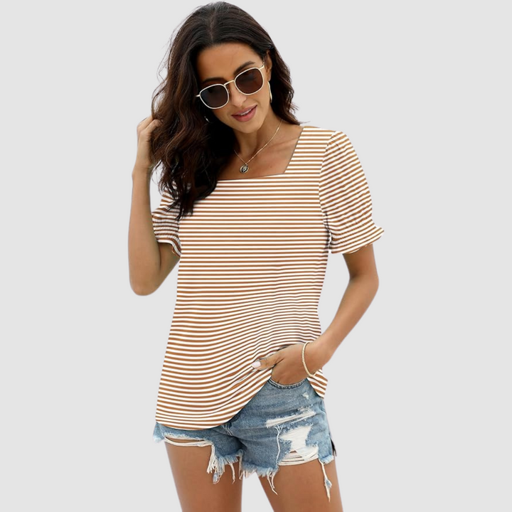 Model in brown-striped top, denim shorts, sunglasses. Classic outfit against plain studio background.