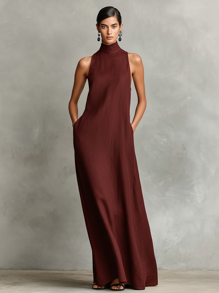 Burgundy maxi dress with high neck and sleeveless design worn by a person in studio setting.