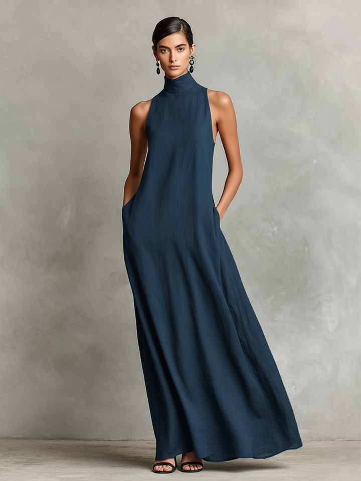 Teal maxi dress with high neckline and sleeveless design, modeled in a neutral studio setting.