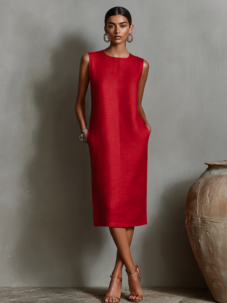 Red midi dress with pockets, sleeveless design, worn by model in elegant studio setting.