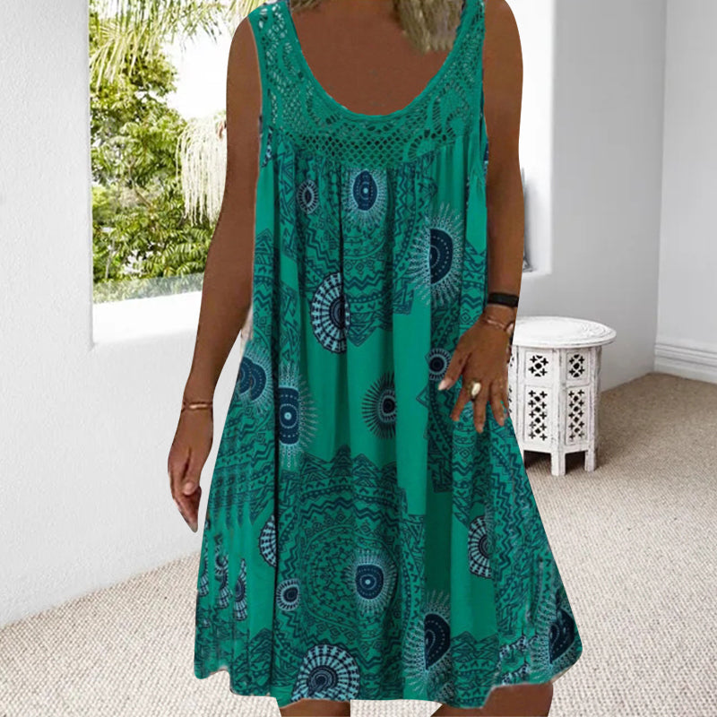 Woman in green printed dress in a luminous room with garden view.