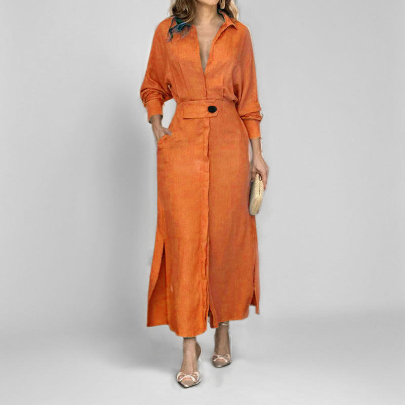 Woman in orange midi dress with deep V-neck and single button detail posing in a minimalist studio setting.