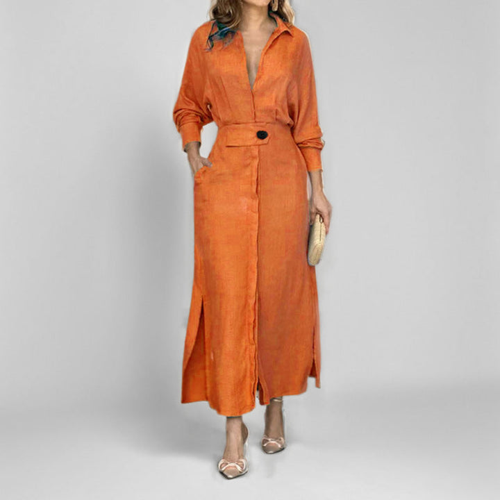 Woman in orange midi dress with deep V-neck and single button detail posing in a minimalist studio setting.