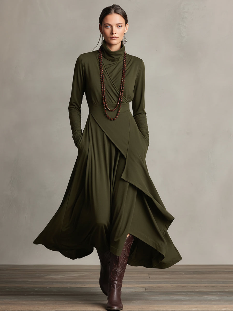 Woman in an olive green stretch maxi dress with flowing layers and long sleeves, in a studio setting.