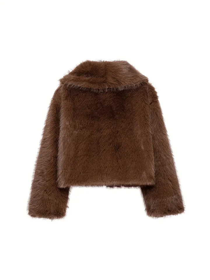 Back view of a brown fur jacket, highlighting its fluffy texture and sophisticated cut, on a white backdrop.