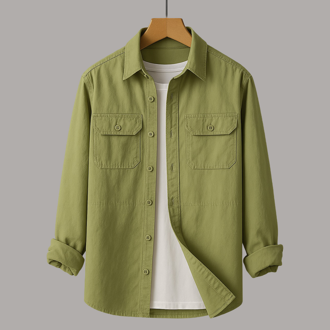 Olive shirt with chest pockets over a white tee on wooden hanger, gray studio background.