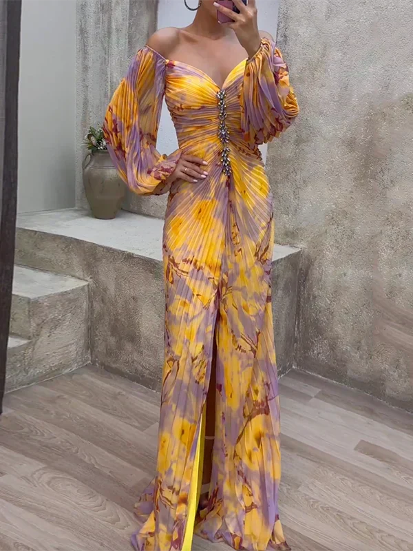 Yellow and purple off-shoulder dress with ruched front, worn indoors against a textured wall with a vase on a step.