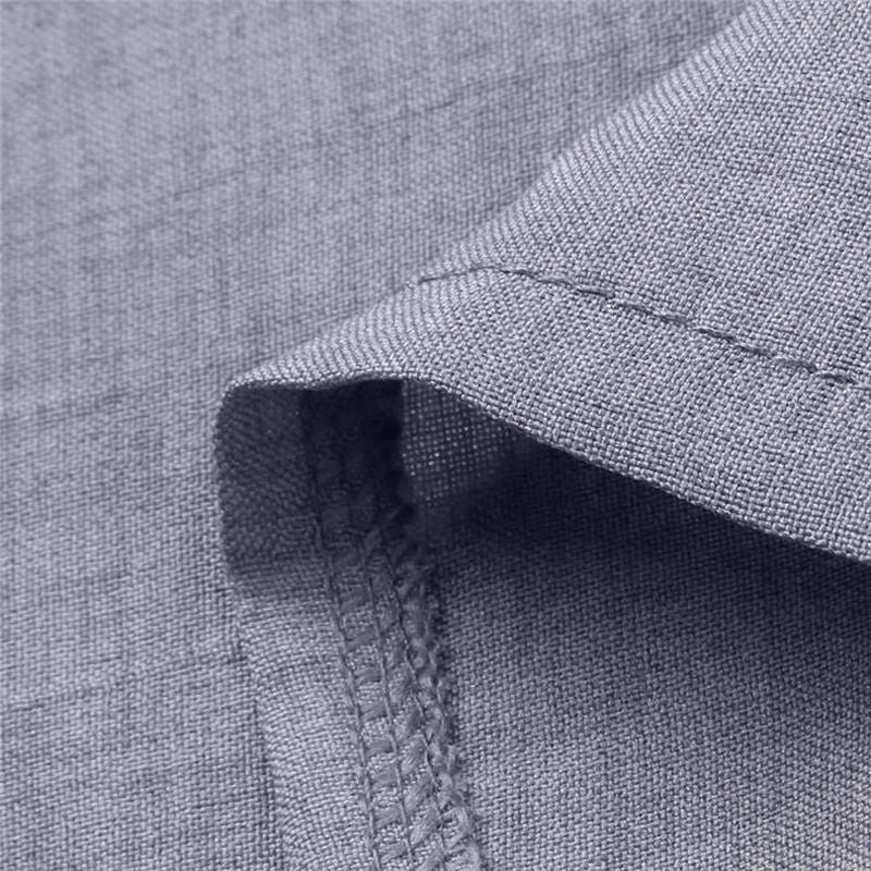 Close-up of textured grey fabric showcasing detailed stitching in studio setting.