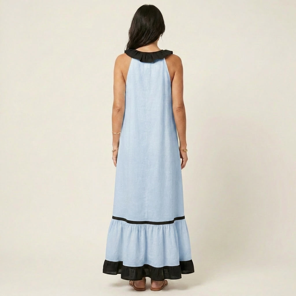 Back view of woman in light blue sleeveless maxi dress with ruffle-neck and contrast trim in studio.