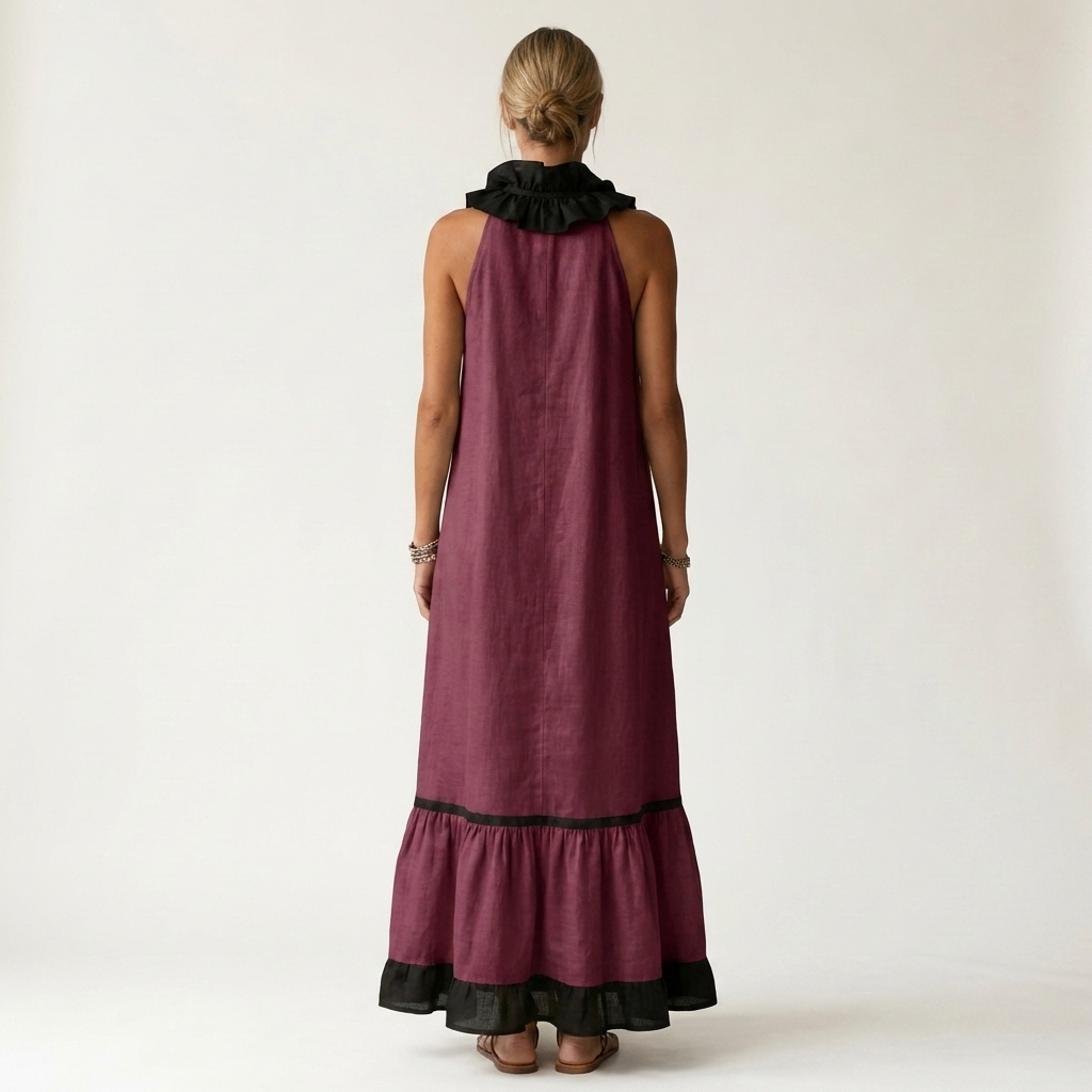 Back view of woman in burgundy sleeveless maxi dress with ruffle-neck and contrast trim in studio.