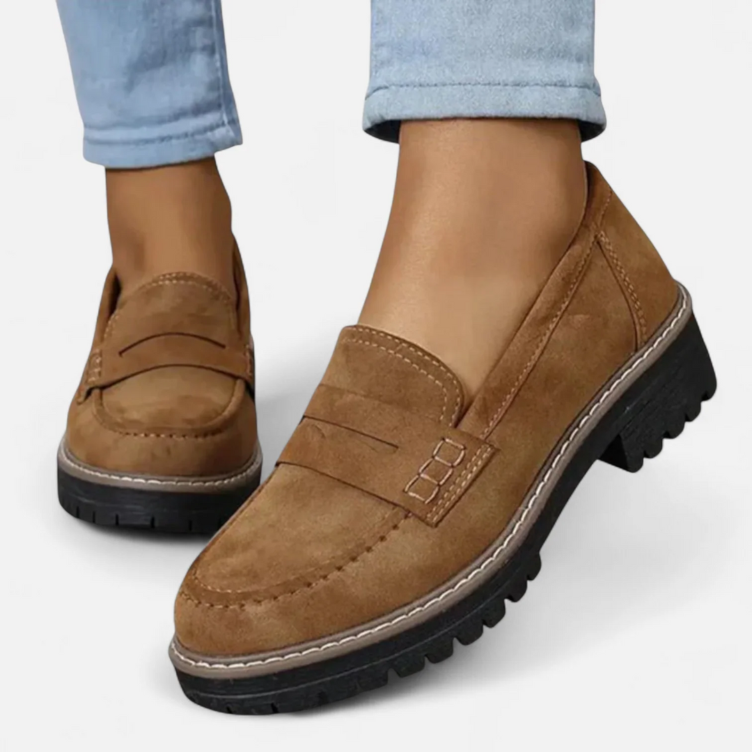 Brown orthopedic moccasins with light blue jeans, positioned on a white background.