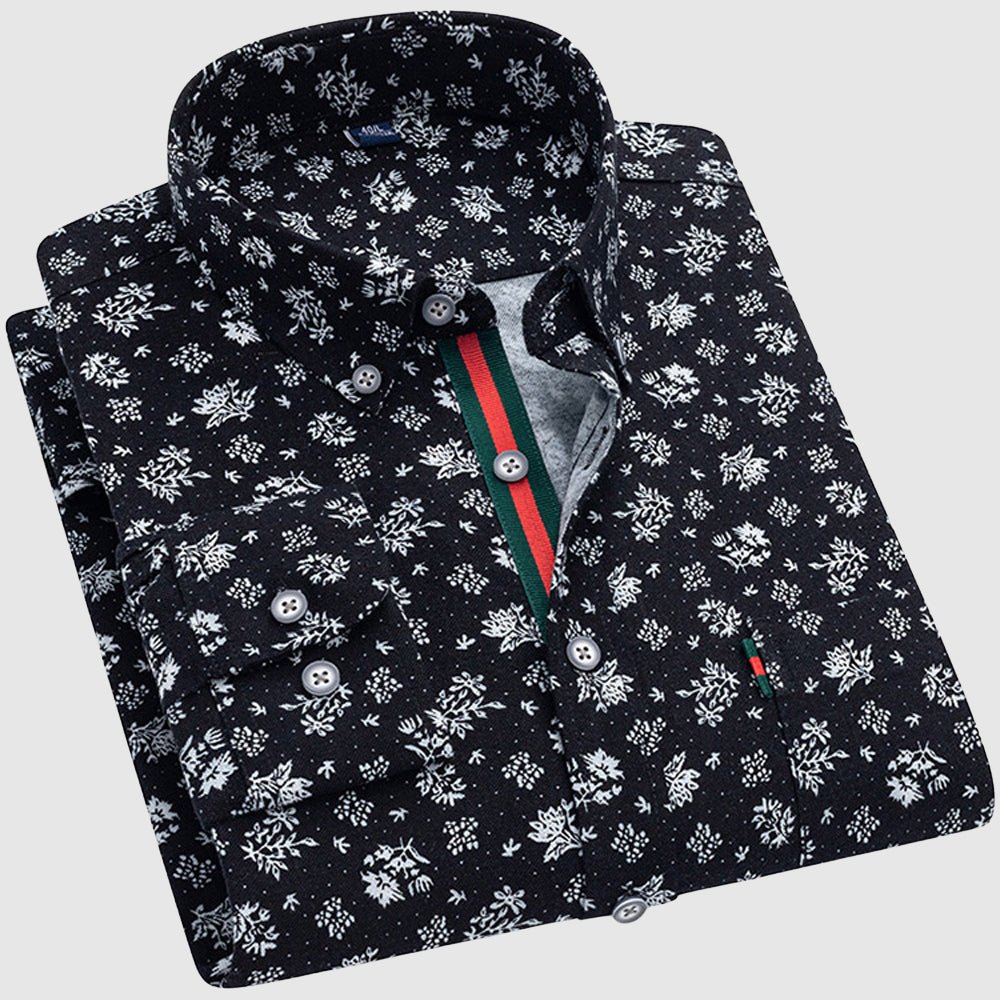 Black floral shirt with white patterns, button-up collar, and contrasting interior stripe, studio background.