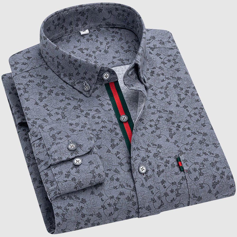 Grey floral shirt with dark patterns, button-up collar, and colorful interior stripe, studio setting.