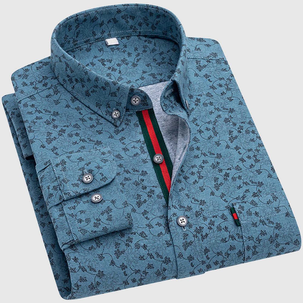 Blue floral shirt with dark patterns, button-up collar, and colorful interior stripe, studio setting.