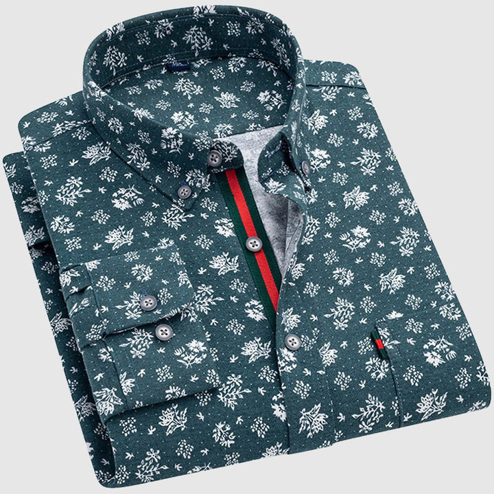 Green floral shirt with white patterns, button-up collar, and colorful interior stripe, studio background.