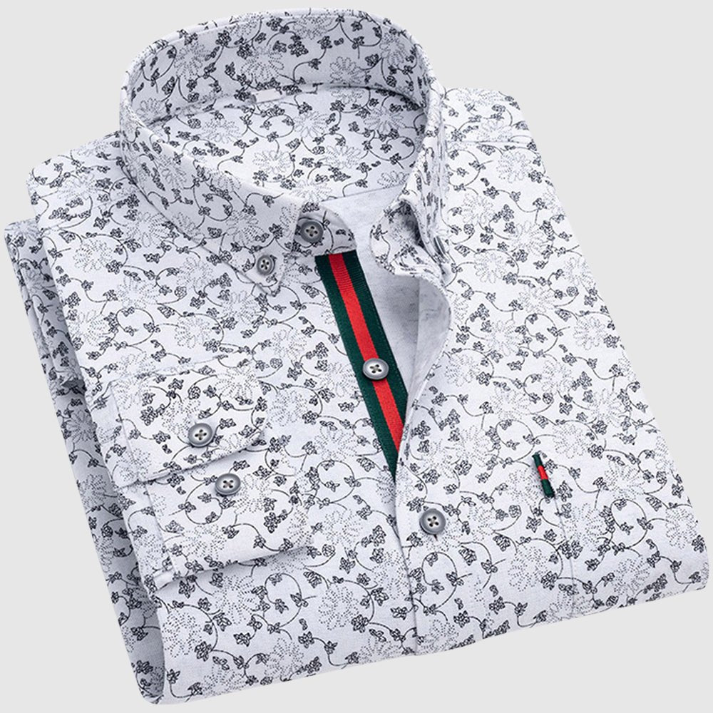 White floral shirt with black patterns, button-up collar, and contrasting interior stripe, studio backdrop.