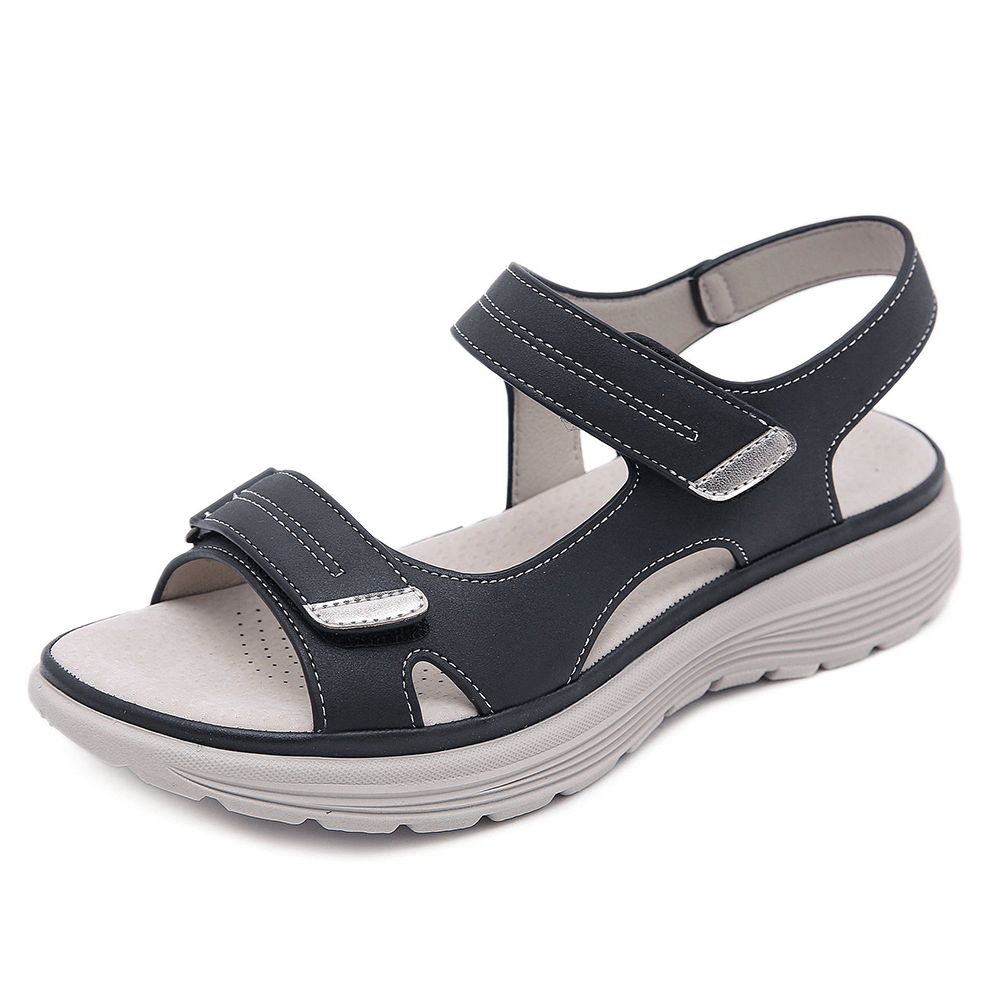 Black orthopedic sandal featuring adjustable straps and cushioned sole, studio background.