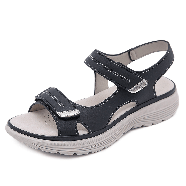 Black orthopedic sandal featuring adjustable straps and cushioned sole, studio background.
