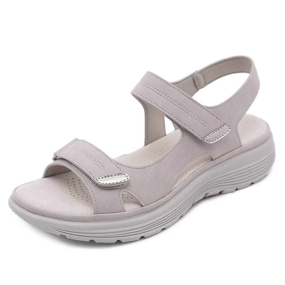Light gray orthopedic sandal with adjustable straps and cushioned sole, studio background.