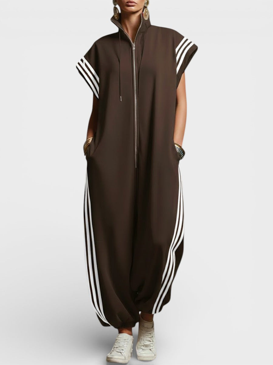 Model in brown zip neck jumpsuit with white side stripes and cap sleeves, studio setting.