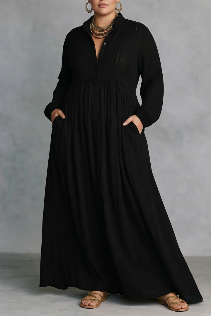 Black flowing button-front maxi dress with long sleeves in a studio setting.