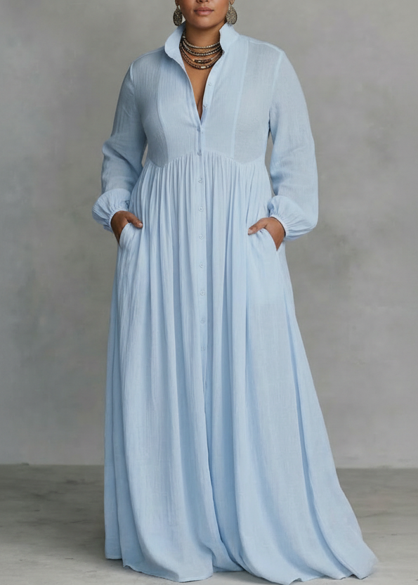 Light blue flowing button-front maxi dress with long sleeves in a studio setting.