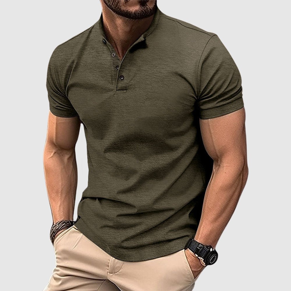 Man wearing a dark green breathable polo shirt with buttoned collar, paired with beige pants, in a studio setting.