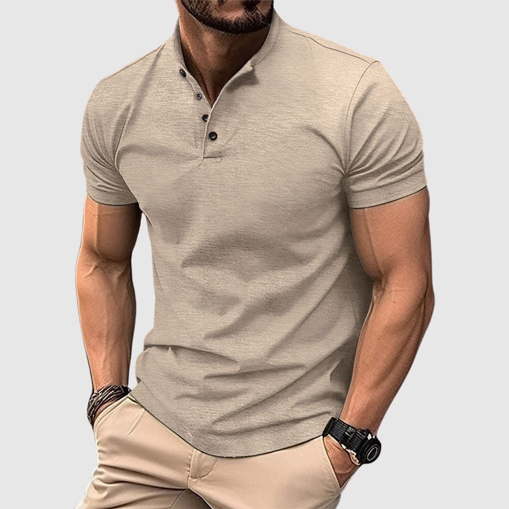 Man wearing a beige breathable polo shirt with buttoned collar, paired with beige pants, in a studio setting.