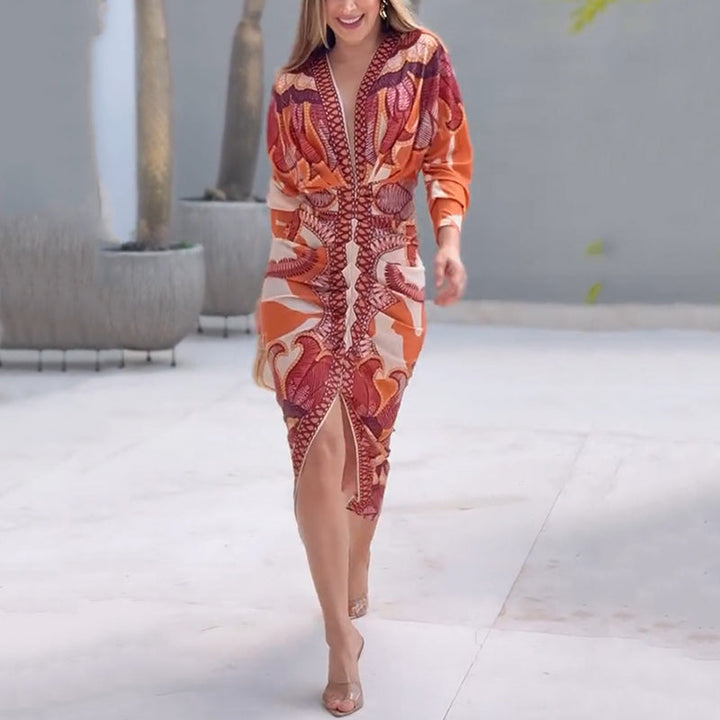 Stylish V-neck dress with striking orange and red patterns, showcased outdoors on a smooth walkway.