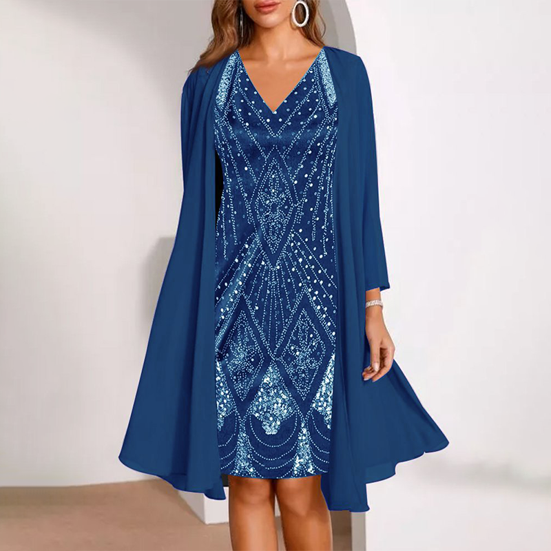 Elegant two-piece dress in navy blue with delicate patterns, paired with a flowing cardigan. Studio background.