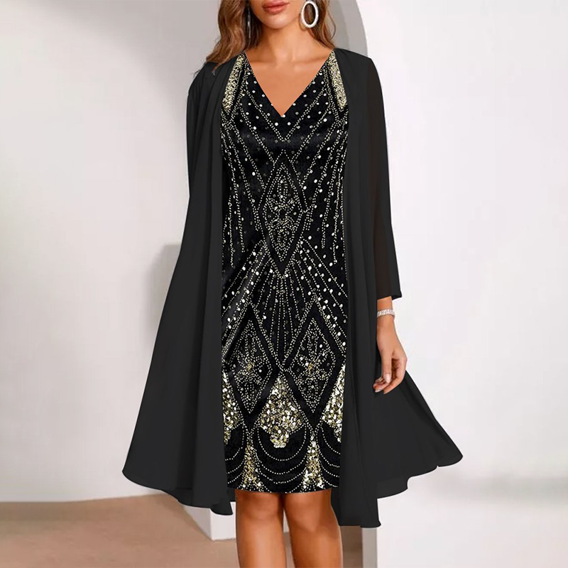 Elegant two-piece dress in black with ornate patterns, accompanied by a flowing cardigan. Studio background.