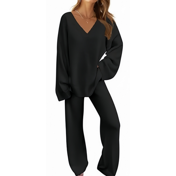 Black V-neck long sleeve sweater and pants set on a person, posed against a plain white background.