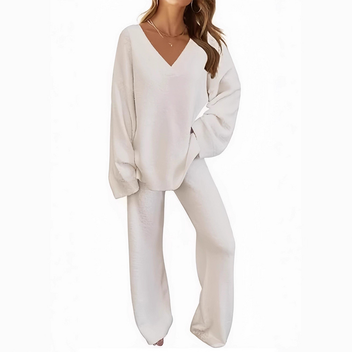 White V-neck long sleeve sweater and pants set on a person, posed against a plain white background.