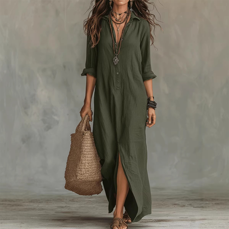 Green relaxed midi dress with button front, long sleeves rolled up, accessorized with layered necklaces, straw tote, against a neutral studio background.