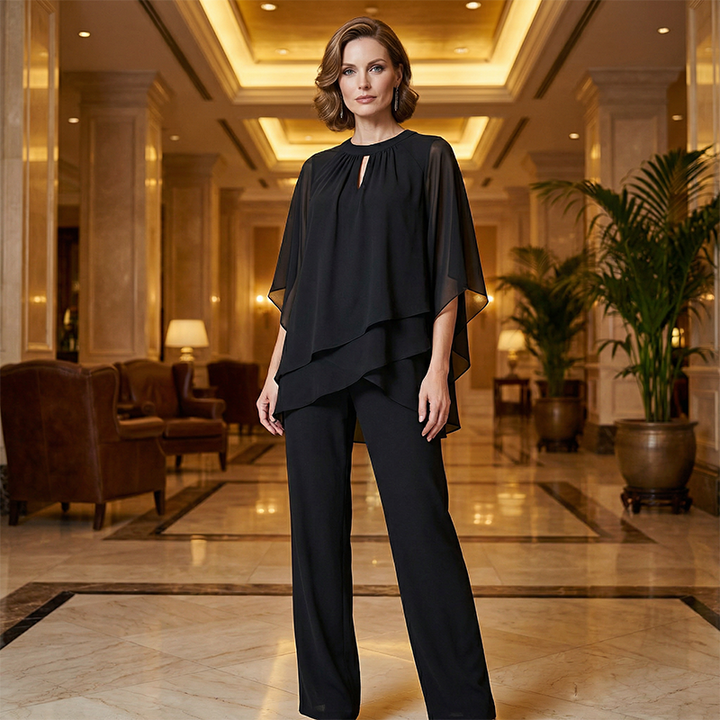 Black elegant set worn in luxurious hotel lobby with warm lighting.