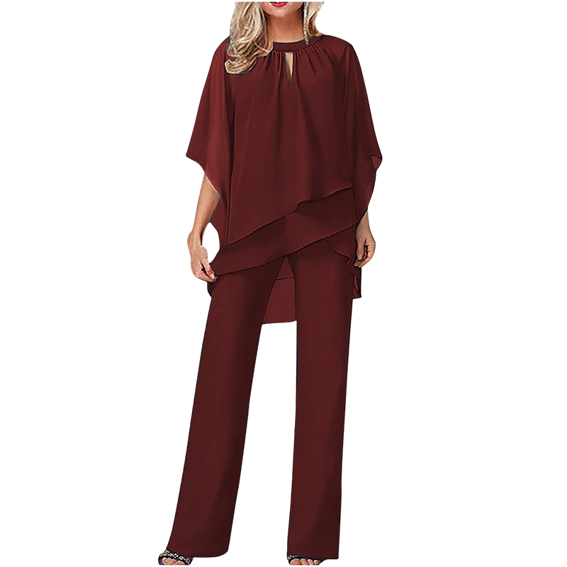 Wine red elegant set with layered top and wide-leg pants in a studio setting.