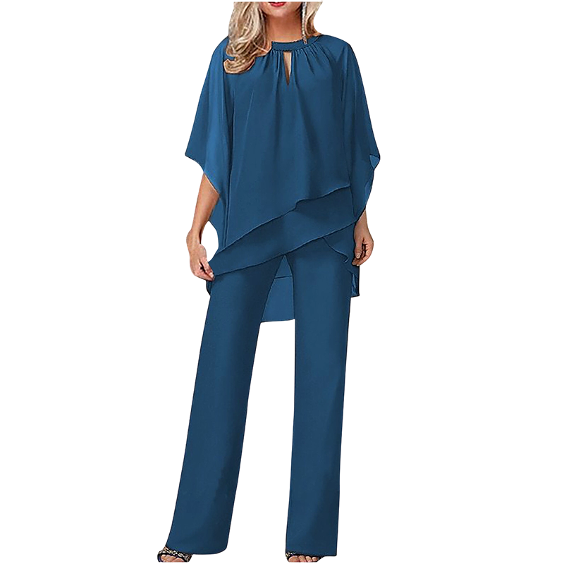 Blue elegant set with layered top and wide-leg pants in a studio setting.