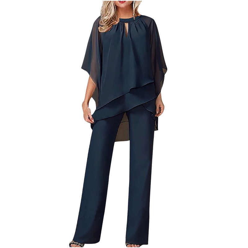 Dark blue elegant set with layered top and wide-leg pants in a studio setting.