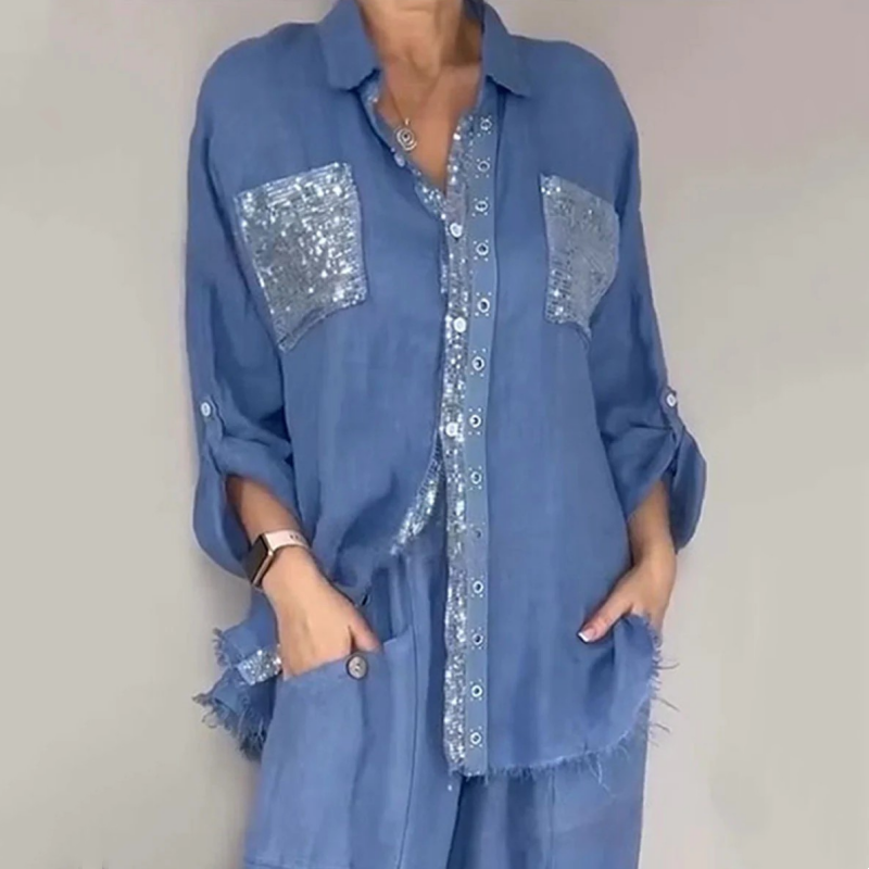 Blue elegant set featuring sequin pockets and button detailing, modeled in neutral studio setting.