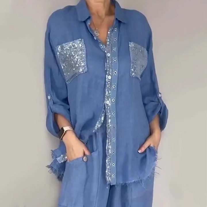 Blue elegant set featuring sequin pockets and button detailing, modeled in neutral studio setting.