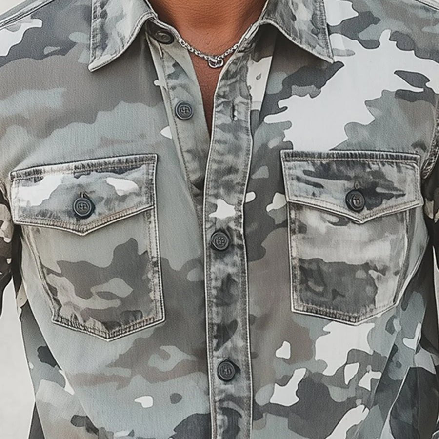 Close-up of gray camo shirt with front pockets and button details.