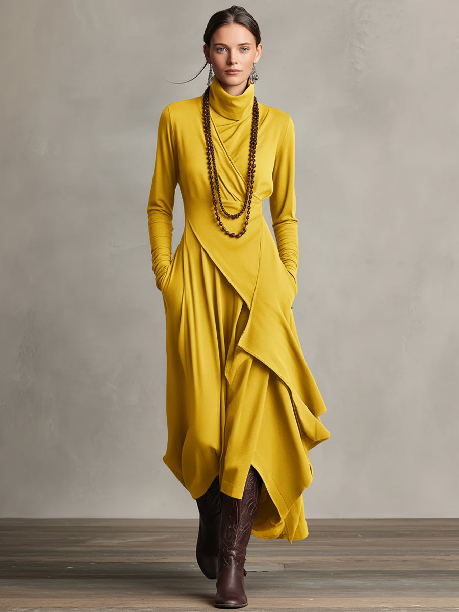 Woman in a mustard yellow stretch maxi dress with flowing layers and long sleeves, in a studio setting.